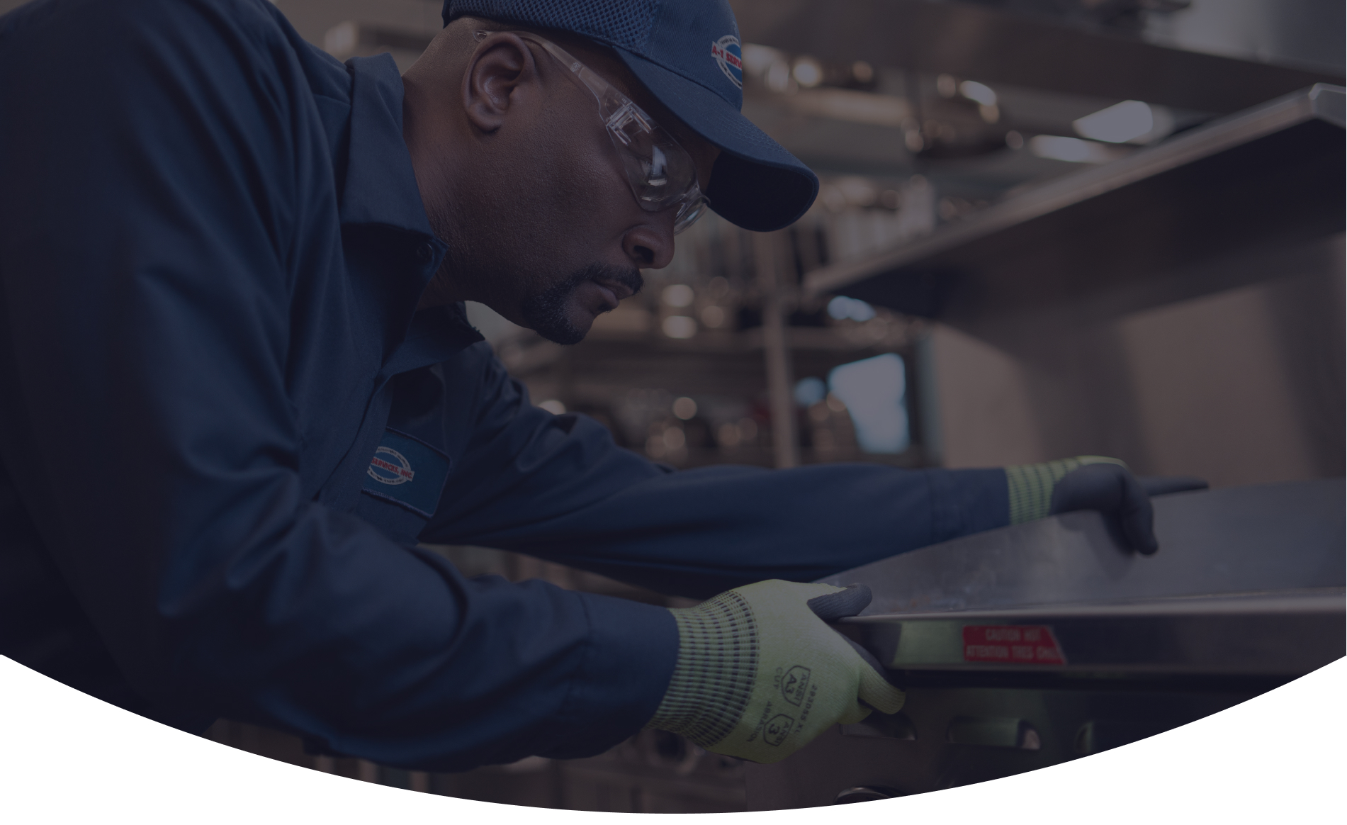 A-1 Services Group technician in safety glasses servicing a commercial cooking appliance